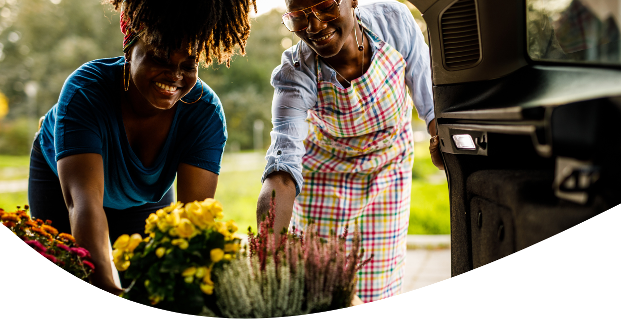 Family unloading gardening supplies from car at home
