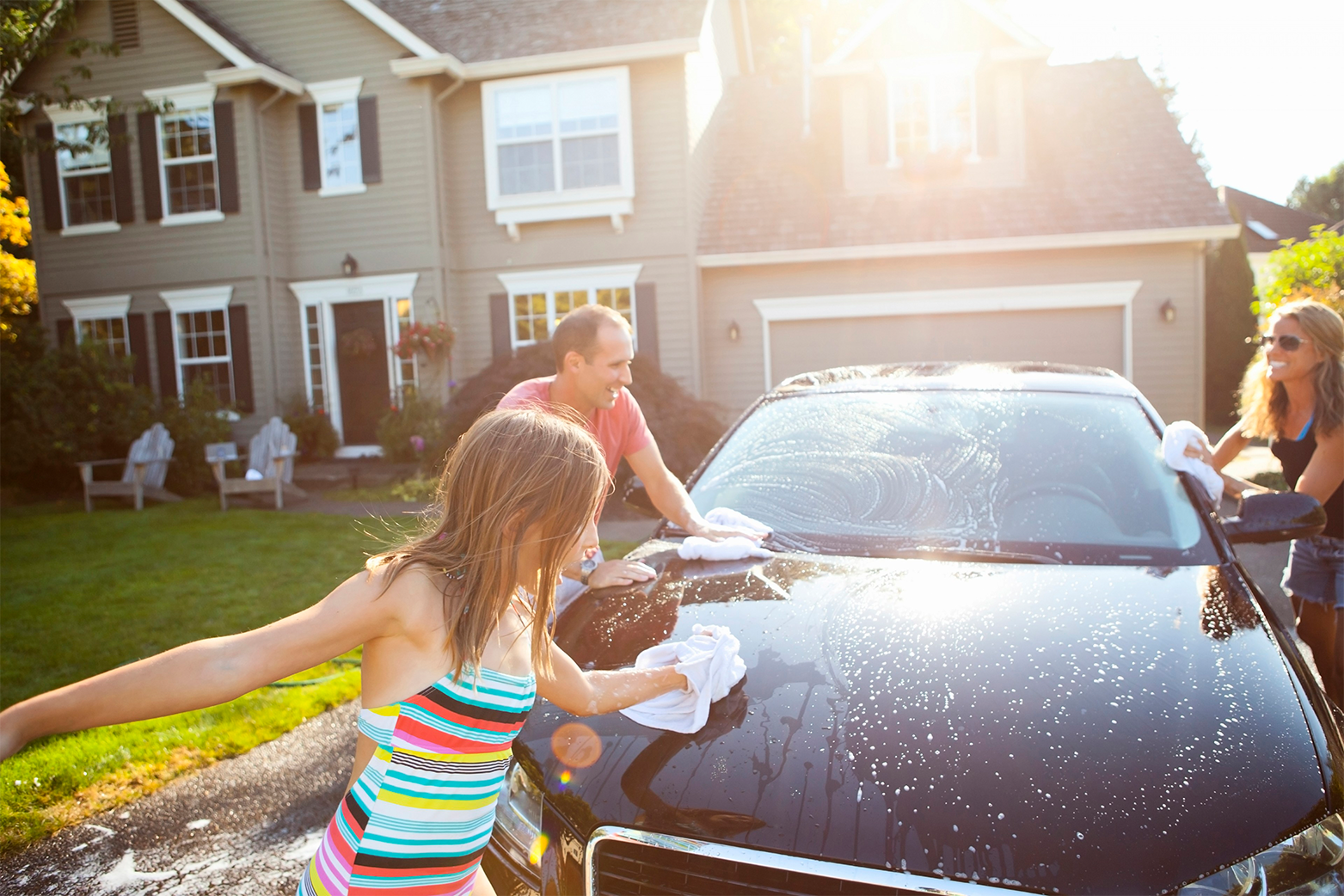 family washing car - travelers insurance image